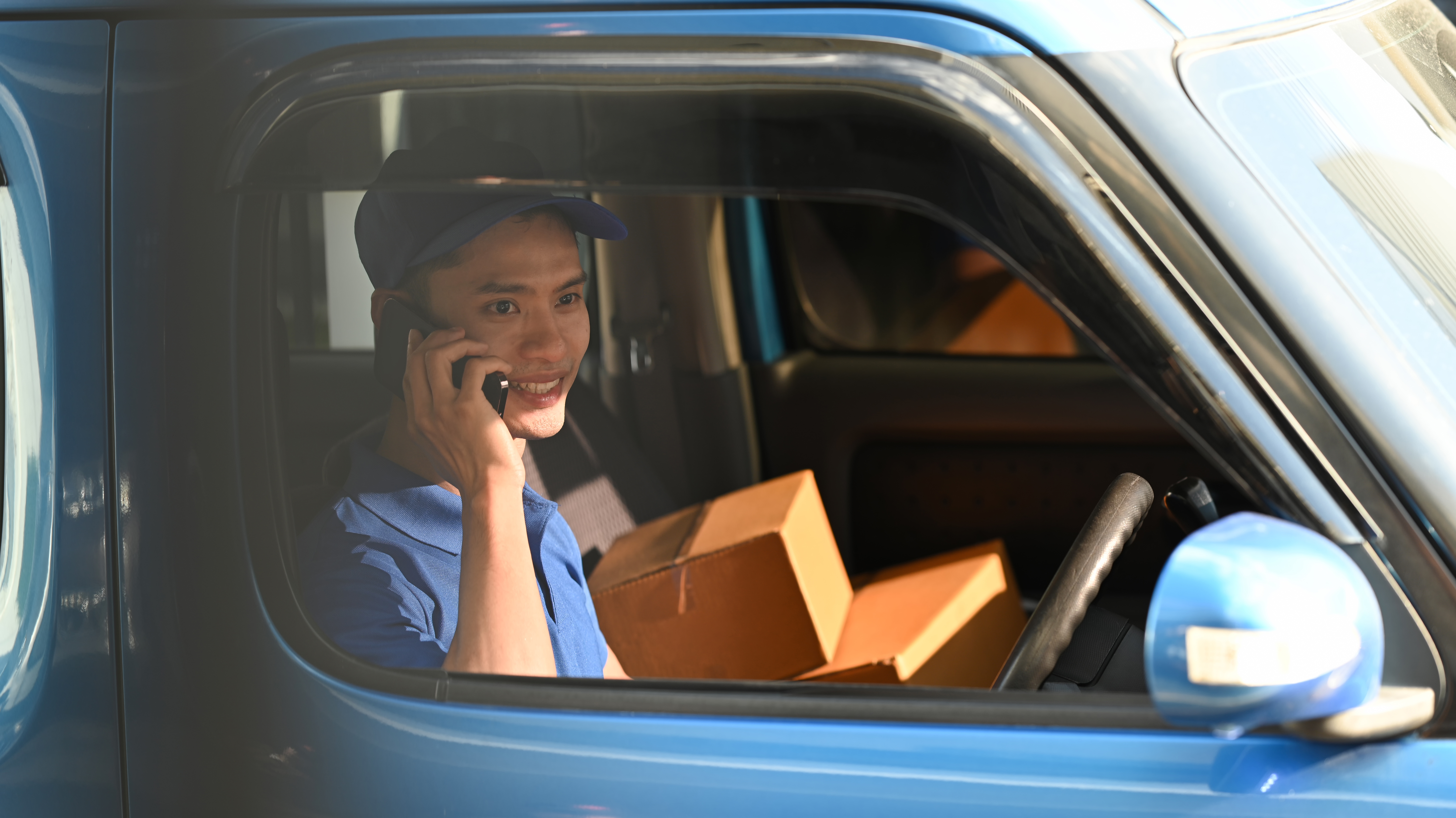 Delivery driver on the phone in the field